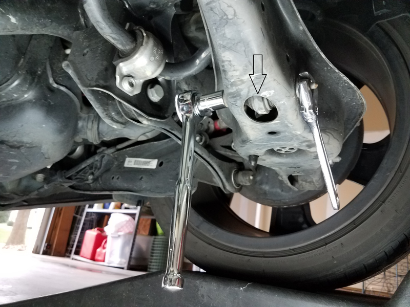 Arrow points to endlink bottom peeking through the control arm.